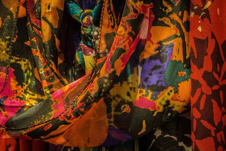 Closeup of a group of scarves hanging in a closetの写真素材