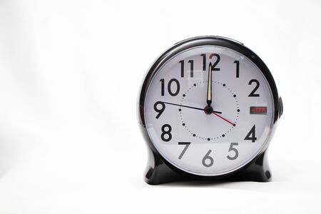 Clock face showing noon or midnight on a high key background, pushed rightの写真素材