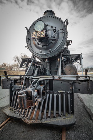 The nose and cow-catcher of a steam locomotive on a track in Reading, PA
