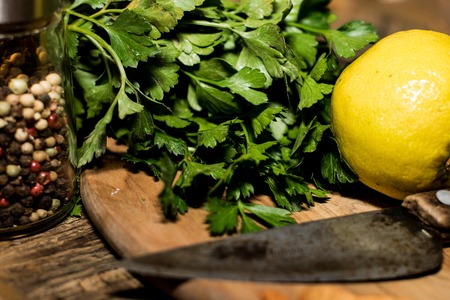 parsley and lemon are prepared for a delicious mealの写真素材