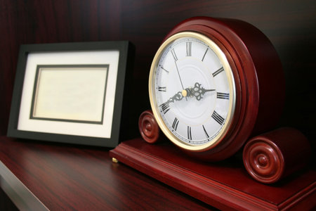 Clock with a blank picture frame beside it. Good for timeless / timely memories