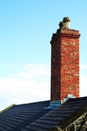 Chimney on the roof of a stone built house.の写真素材