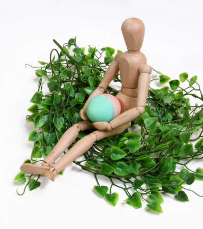 Mannequin holding an easter egg in a nestの写真素材