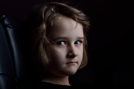 Low-Key portrait of a little cute blonde girlの写真素材