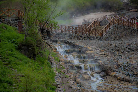 Small waterfall near a stone pathwayの写真素材