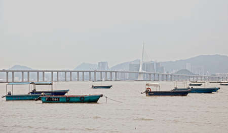Boats are seen in front of Shenzhen Houhai Bay Bridgeのeditorial素材