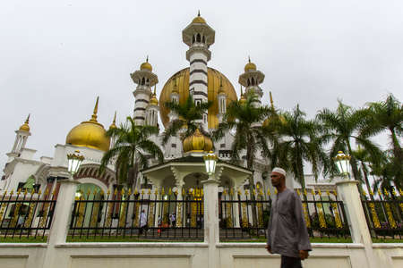 A muslim walks pass Ubudiah Mosque, Kuala Kangsarのeditorial素材