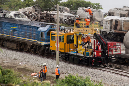 Workers repair high-volt electric line after Batu Gajah Train Accident, the worst train crash of...