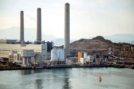 A yacht sails beside the electricity plant of Lamma Island, Hong Kongのeditorial素材
