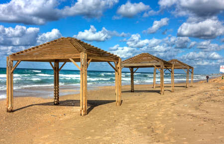 Sea shore and wooden sun shelters  Netanya, Israelの写真素材