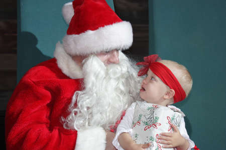 26 December 2010, RCCL Mariner of the Seas: a little girl scared of big bearded Santaのeditorial素材