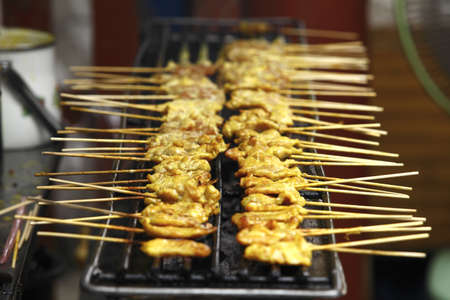 Barbecue Pork spare ribs cooking on a grill outdoors in summerの写真素材