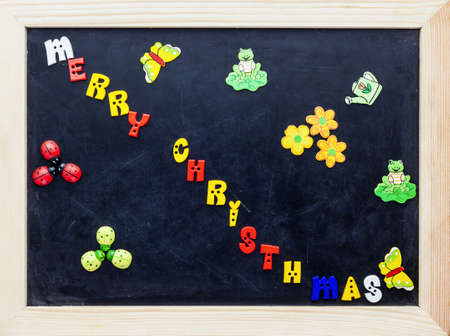 Color merry christmas words on black board.の写真素材
