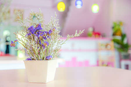 Purple flower pot on table in restaurantの写真素材