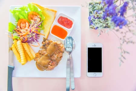 chicken steak and flower and mobile.の写真素材