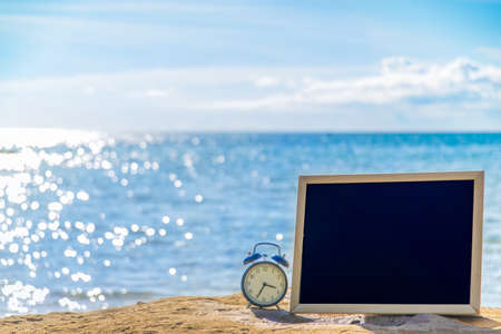 blank black board on tropical beach background.の写真素材