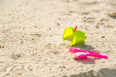 Children's beach toys - buckets, spade and shovel on sand on a sunny dayの写真素材
