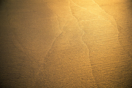 Beautiful golden beach texture as background with sunlightの写真素材