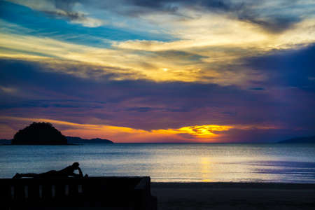 Man sleeping on the sun with beautiful sky.の写真素材
