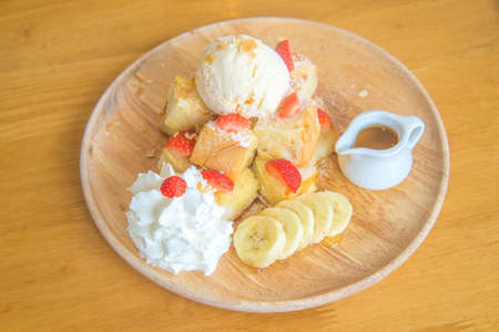strawberry honeytoast on wooden dish and wooden tableの写真素材