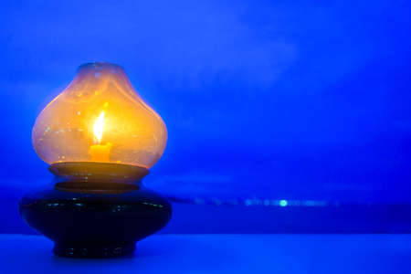 Simple lantern on table and blue sky (space for text).の写真素材