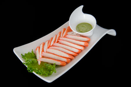 crab stick with wasabi on blackの写真素材