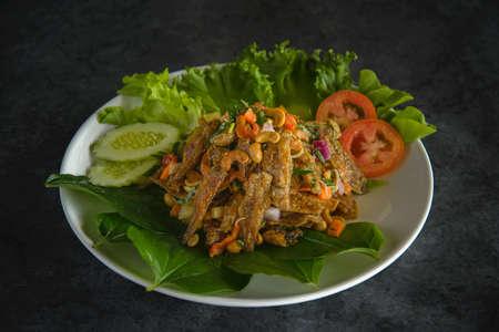 fried fish spicy salad with herb.の写真素材