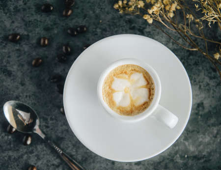 hot espresso coffee  and flower art on top.の写真素材