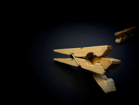 Fighting of wooden clothespins on dark background. Illustration aggression issues. Part of photoset.の写真素材