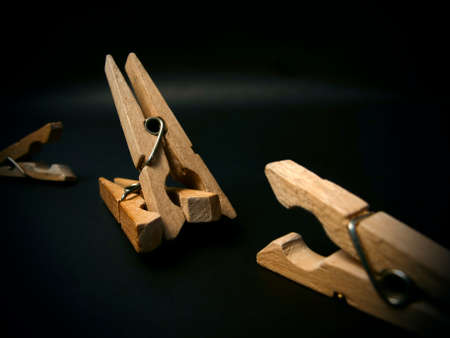 Fighting of wooden clothespins on dark background. Illustration aggression issues. Part of photoset.の写真素材