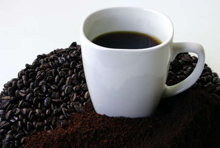 Mug of Coffee Surrounded by Coffee Beansの写真素材