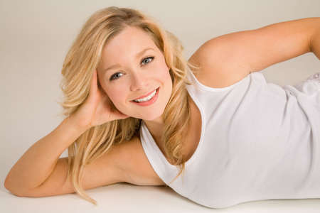 Beautiful Smiling Blonde Lying Downの写真素材