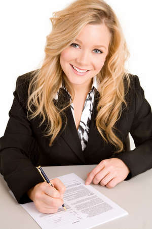 Beautiful Businesswoman Signing a Documentの写真素材