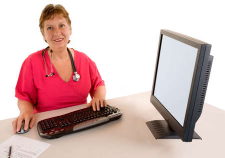 Smiling Beautiful Middle Aged Nurse or Doctor  Sitting at her Deskの写真素材