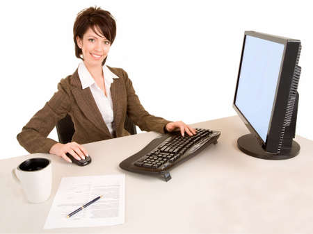 Smiling Businesswoman Working at a Computerの写真素材
