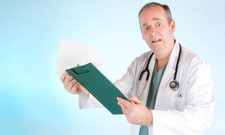 Perplexed Doctor Reading Out Disappointing Medical Test Resultの写真素材