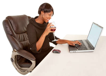 African American Woman Texting to Someone While Drinking Wineの写真素材