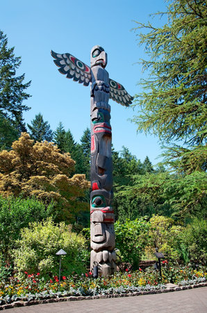 Aboriginal Totem Pole stands in the Butchart Gardens, Central Saanich, BC, Canada