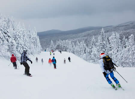 Mont-Tremblant , Quebec, Canada - February 9, 2014  Skiers and snowboarders are sliding down an easy slope at Mont-Tremblant Ski Resort   It is acknowledged by most industry experts as being the best ski resort in Eastern North America  のeditorial素材