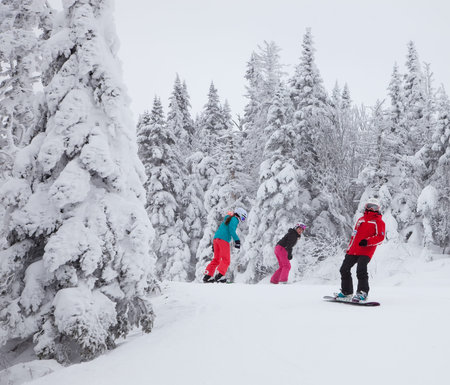 Mont-Tremblant, Canada - February 9, 2014  Snowboarders are sliding down an easy slope at Mont-Tremblant  Mont-Tremblant Ski Resort is acknowledged, by most industry experts, as being the best ski resort in Eastern North America のeditorial素材