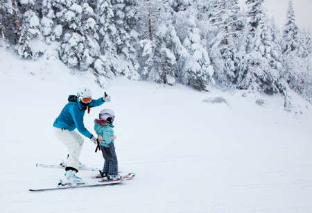 Mont-Tremblant, Canada - February 9, 2014  A mother is teaching her child to ski down an easy slope at Mont-Tremblant Ski Resort  It is acknowledged, by most industry experts, as being the best ski resort in Eastern North America のeditorial素材
