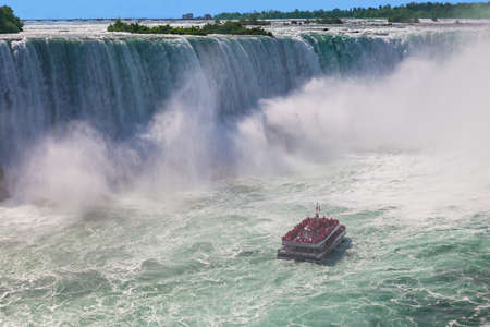 Niagara-Falls, Ontario, Canada - July 5, 2015: View of a tour boat, Hornblower, navigating near the horseshoe falls in Niagara Falls, Ontario, Canadaのeditorial素材