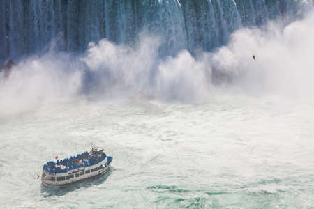 Niagara-Falls, Ontario, Canada - July 5, 2015: View of a tour boat, Maid of the Mist, navigating near the horseshoe falls in Niagara Falls, Ontario, Canada.のeditorial素材
