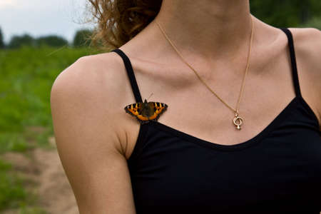 Butterfly on woman breastの写真素材