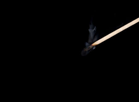 Burned-out match on dark backgroundの写真素材