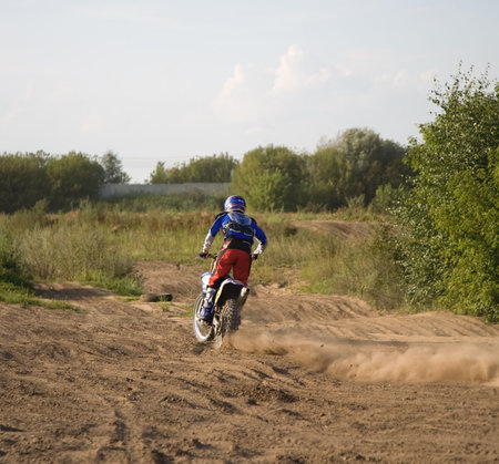 Motorcyclist in action. Ready for jump.の写真素材