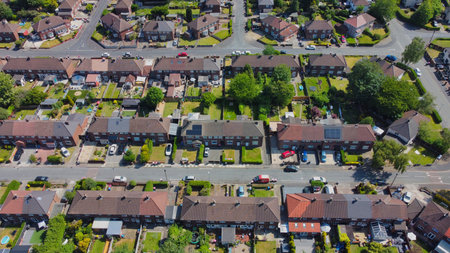 Urban residential neighborhood shows well-maintained homes and greenery in daylightの写真素材