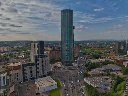 Skyscraper rises above urban landscape in a bustling city during late afternoonの写真素材