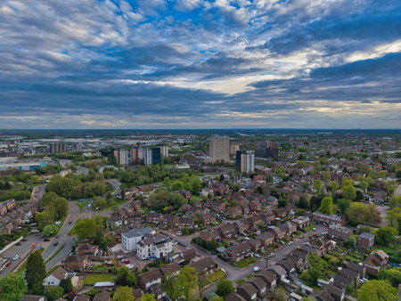 Urban landscape with modern buildings under dramatic cloudy sky in late afternoonの写真素材