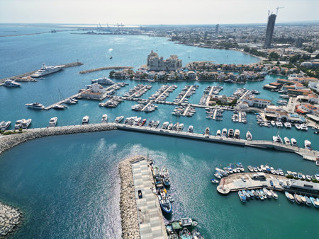 Vibrant marina with numerous boats and luxurious yachts in a coastal city under a clear skyの写真素材